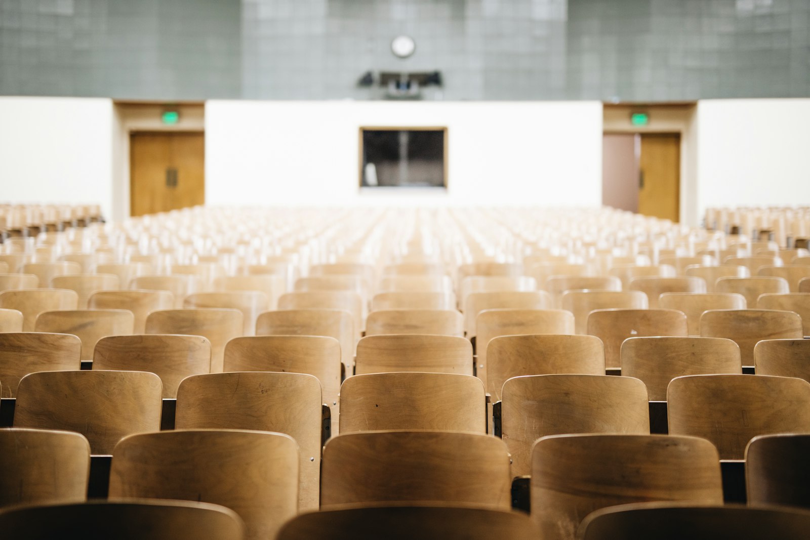Rows of wooden seats in a university lecture hall